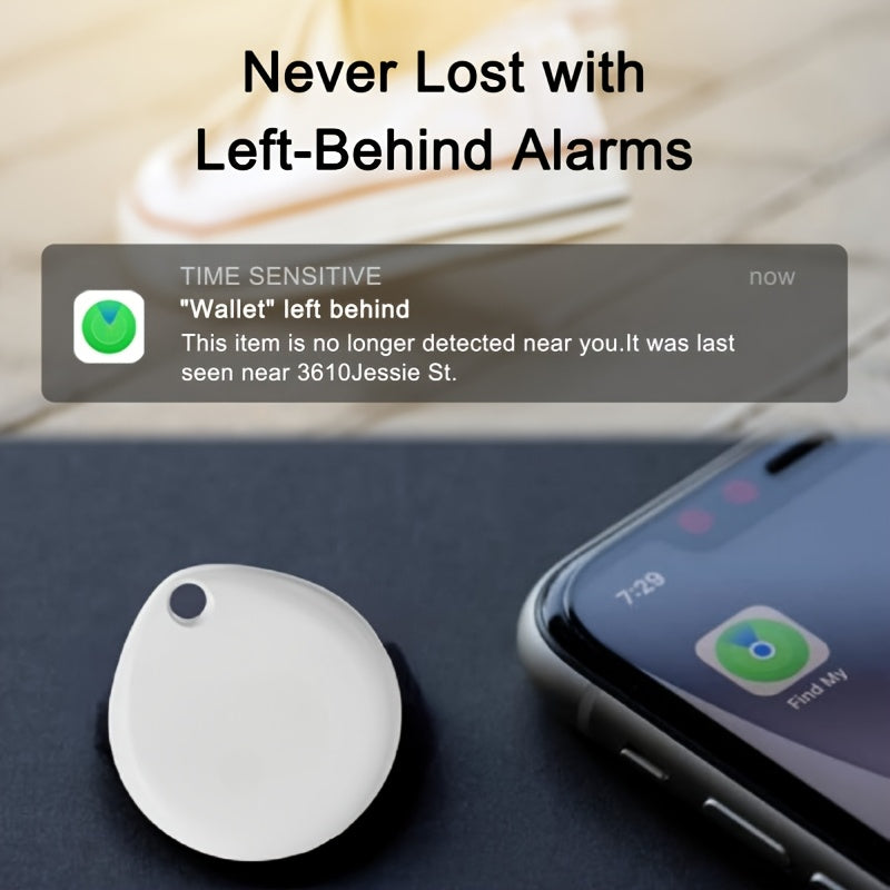 Round white Bluetooth tracker on a table beside a smartphone showing a left-behind alert in the Find My app